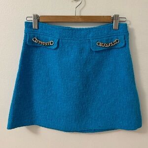 Vibrant light blue Mini Skirt with Gold Chain Detail
